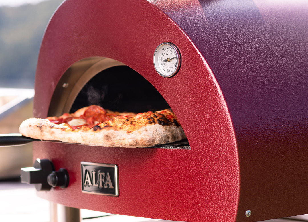 Alfa Forni Moderno Portable Gas Pizza Oven with pizza inside and square launching peel underneath the oven