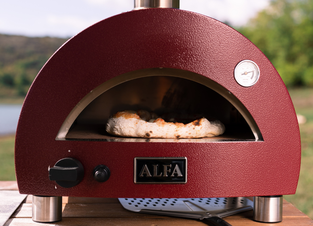 Alfa Forni Moderno Portable Gas Pizza Oven with pizza inside and square launching peel underneath the oven